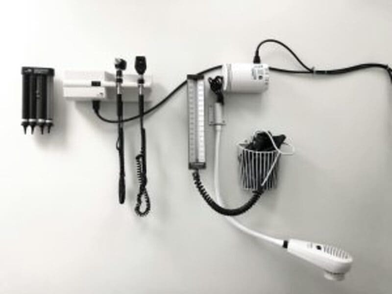 Doctor's Office Exam Room | Image Courtesy of<a href="https://unsplash.com/photos/a-hair-dryer-and-a-hairdryer-on-a-wall-Z3fXPuxa15k"> Abby Anaday</a> (Unsplash)