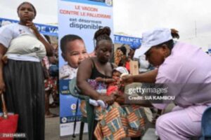 A healthcare worker administers a dose of one of the new malaria vaccines to a baby resting in their mother’s arms in Abidjan, Ivory Coast, Africa.