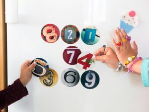 Educational Toys, courtesy of https://unsplash.com/photos/two-children-are-playing-with-magnets-on-a-refrigerator-8v7MrafTx0E