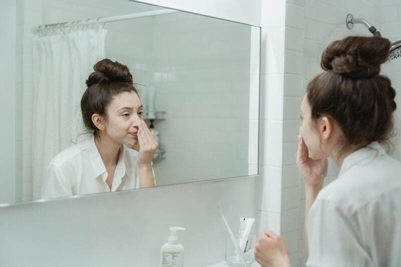 Lady applying skincare product as a beauty hack