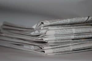 A close-up image of folded newspapers, perfect for news or journalism themes.