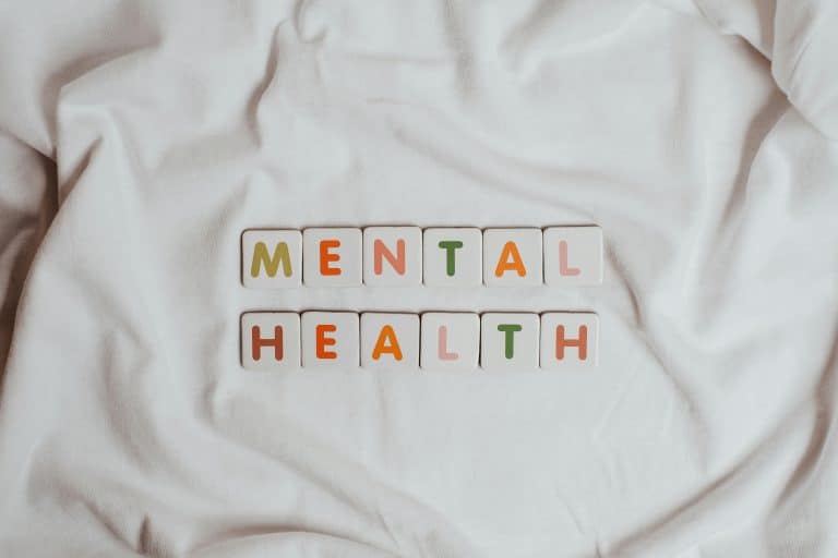 Close-up of 'Mental Health' text on cloth, symbolizing calmness and self-care.
