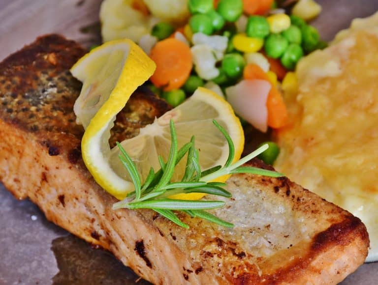 Salmon, which contains Omega-3, is recommended as part of PCOS-friendly diet. The accompanying fresh produce can also be helpful dietary additions.