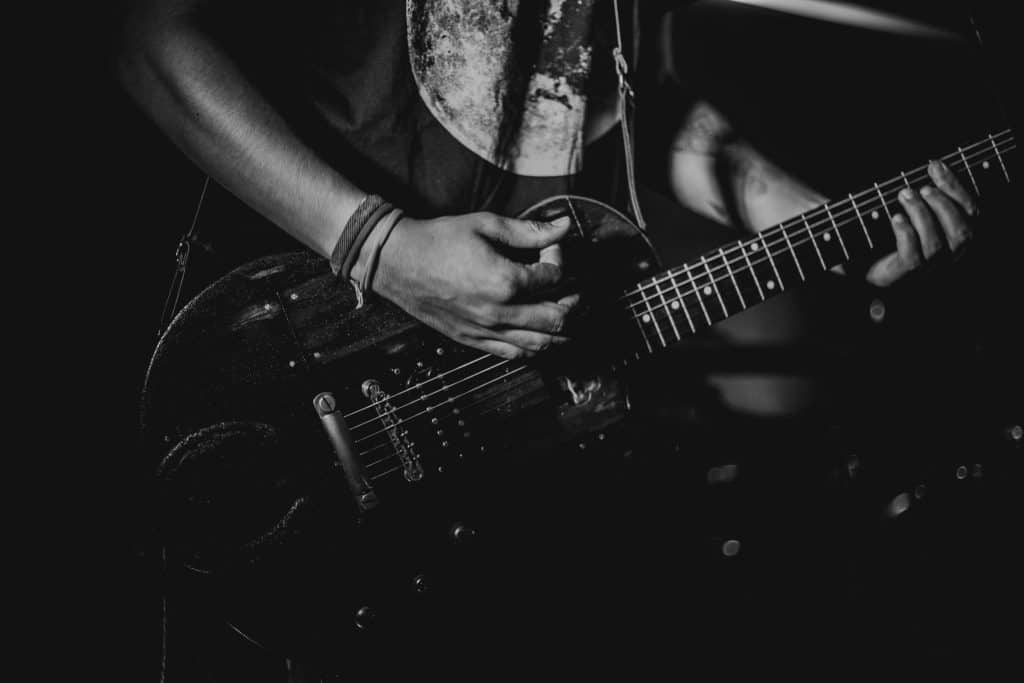 Black and white photo of a guitarist playing during a live performance. ACM Awards