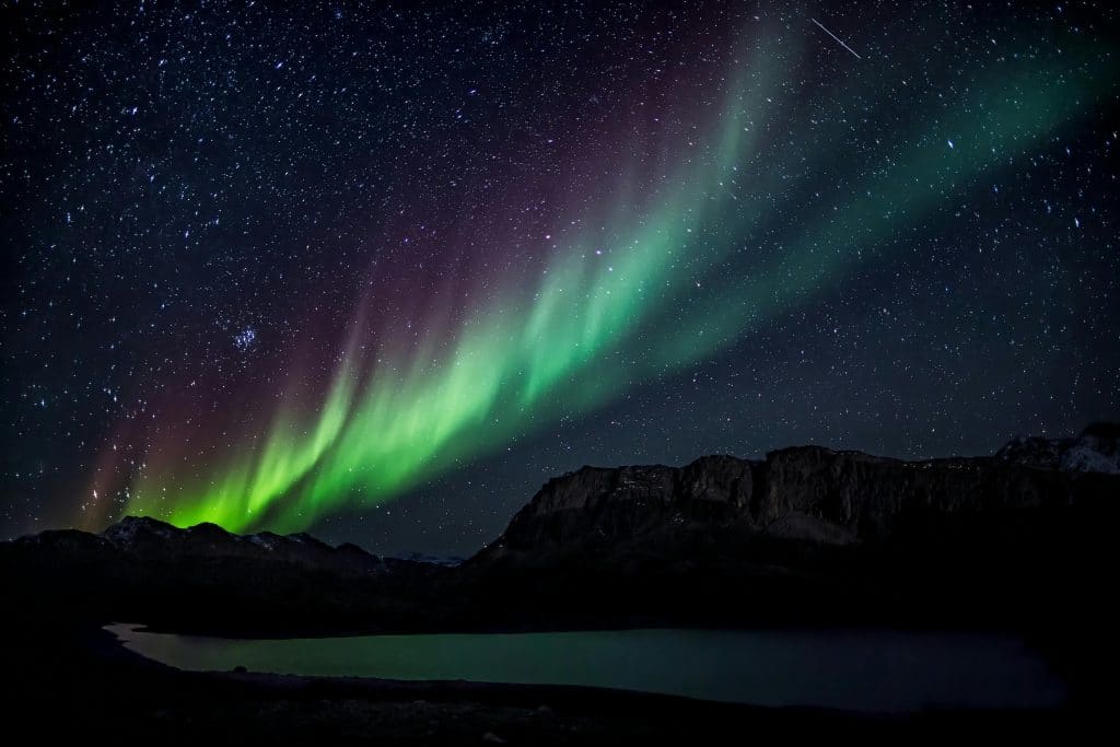 Mesmerizing aurora borealis illuminating the night sky over a serene landscape, capturing nature's beauty. Northern lights