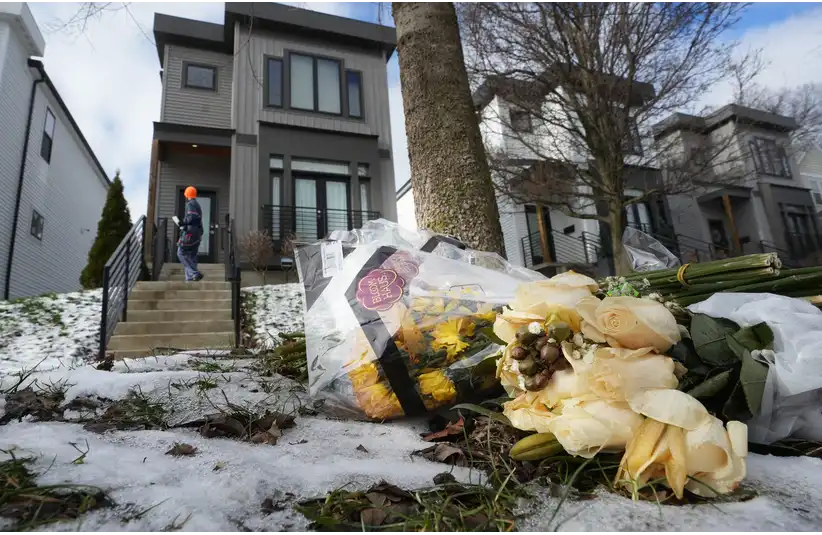 Bouquet of yellow and white flowers lies on snow near a modern house. A person wearing an orange hat walks up the steps. The scene is somber and reflective, and is where Monique and Spencer Tepe were found murdered.Bouquet of yellow and white flowers lies on snow near a modern house. A person wearing an orange hat walks up the steps. The scene is somber and reflective, and is where Monique and Spencer Tepe were found murdered.