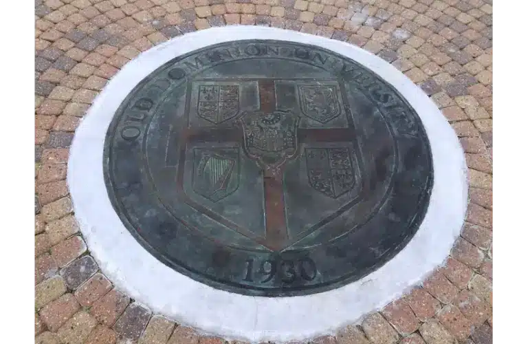 Circular emblem embedded in a cobblestone pathway, featuring "Old Dominion University" text and a 1930 date, with intricate shield designs. ROTC is a program there and there was terror that happened.