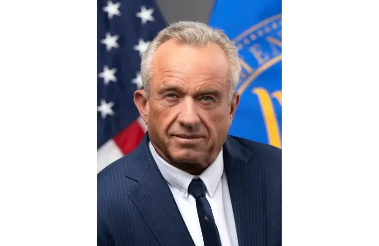 Image of Robert F. Kennedy Jr. in a suit and tie with the American flag in the background.
