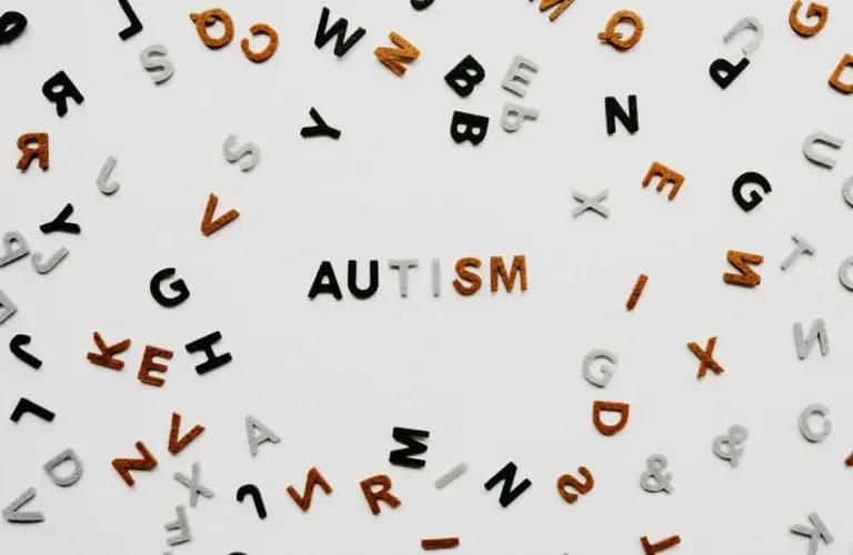 Image of letters on a white background. the word 'autism' in front.