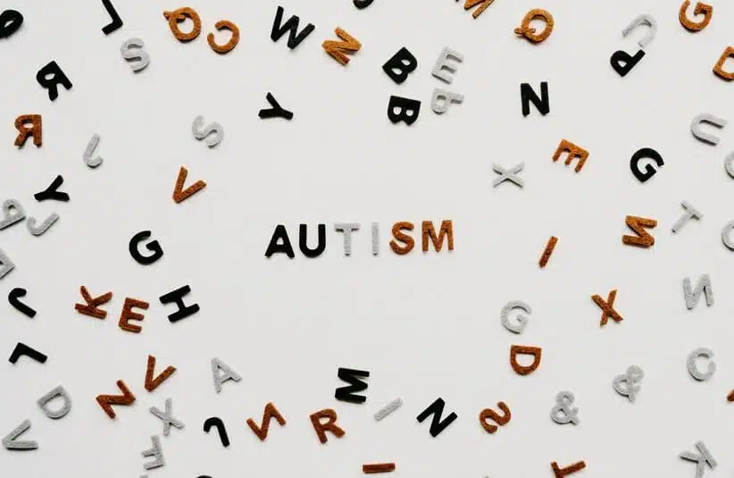 Image of letters on a white background. the word 'autism' in front.