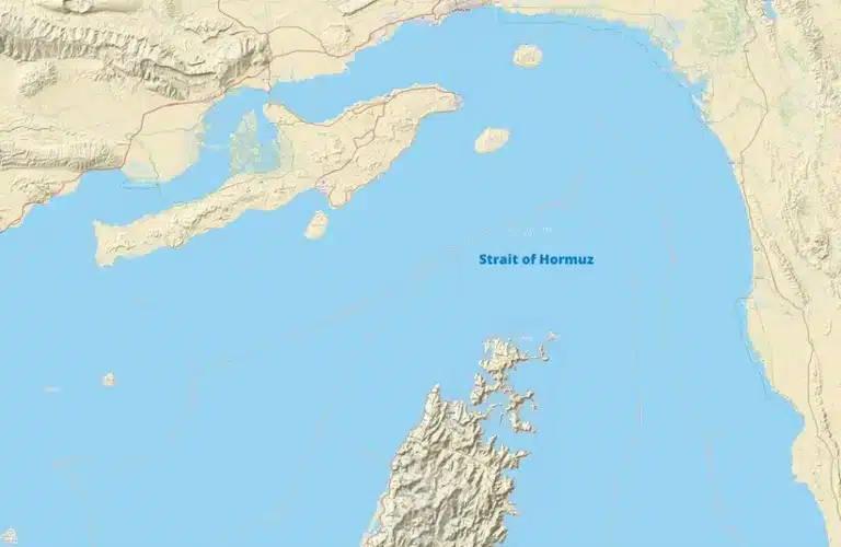 Map of the Strait of Hormuz showing surrounding landmasses and waterways. The terrain is depicted in beige and ocean areas in blue.