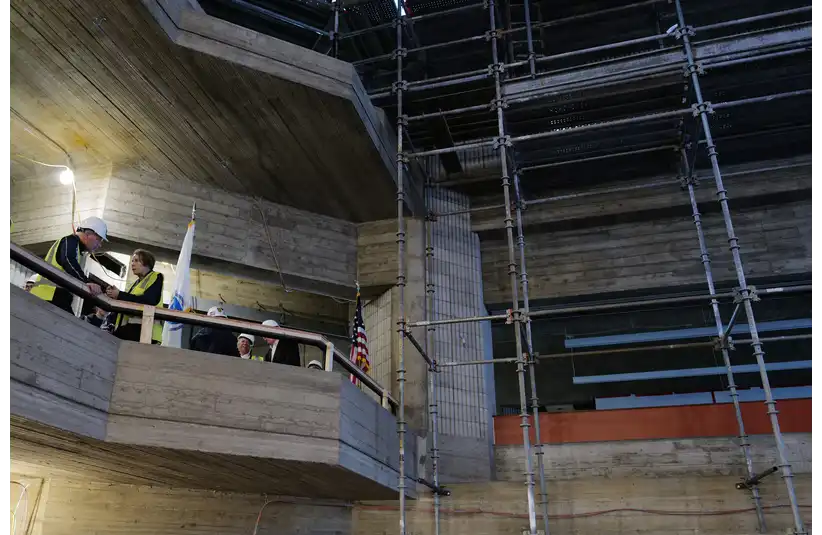 Massachusetts Governor Maura Healey speaks with an attendee of the tour of the UMass Dartmouth Liberal Arts and Sciences (LARTS) building which is currently undergoing an extensive restoration