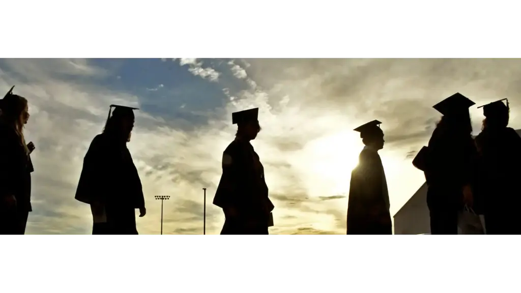 Students walking towards teacher on graduation day