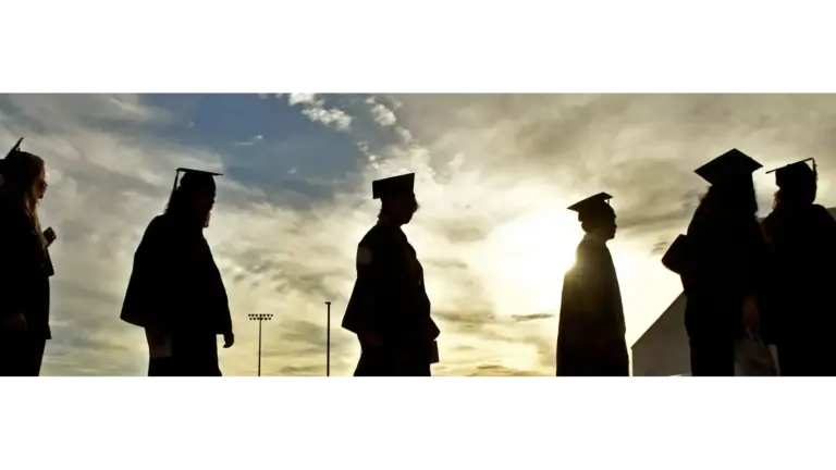 Students walking towards teacher on graduation day