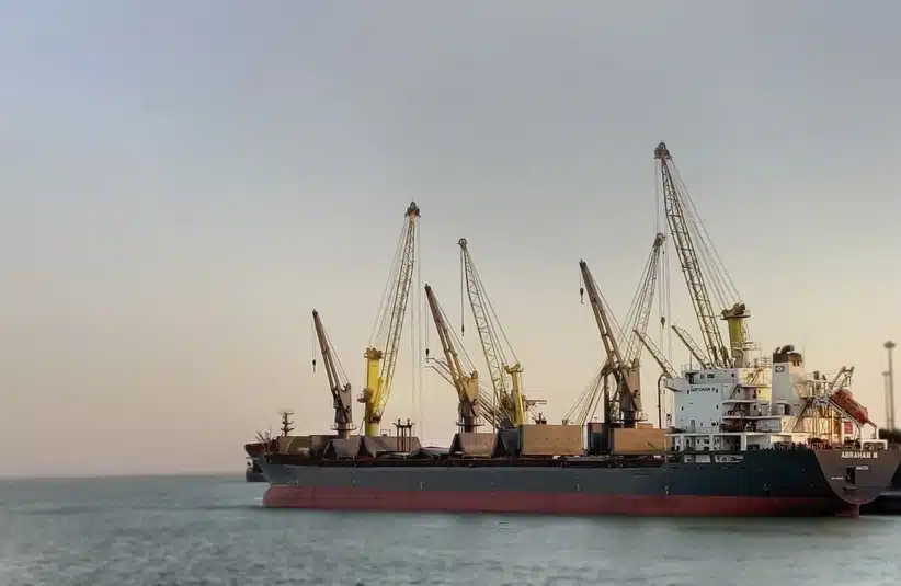A bulk carrier ship, designed to transport large amounts of cargo docked at port in Iran