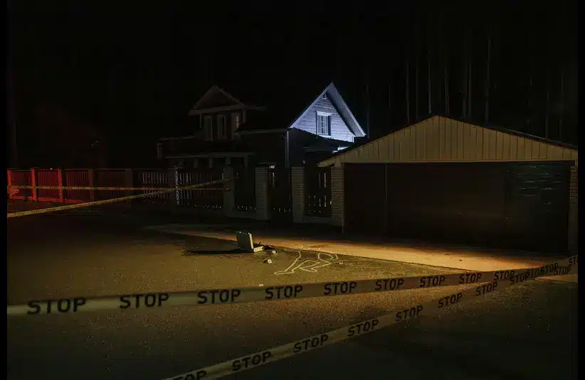 Houston murder-suicide A nighttime crime scene with a house in the background, surrounded by "STOP" tape. Chalk outline of a body and scattered evidence are visible on the pavement.