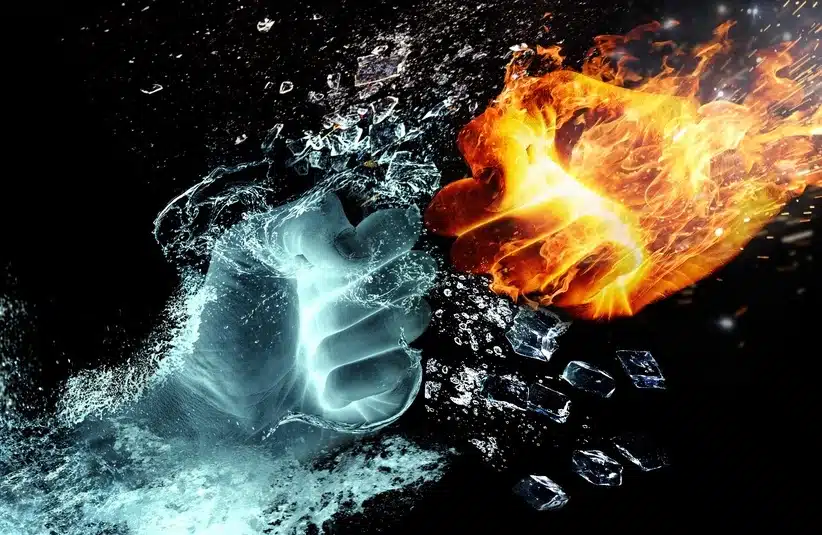 Two fists of opposing elements to symbolize conflict along the Strait of Hormuz amid missile and drone strikes along the waterway.