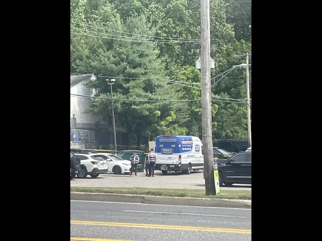 Image of 3 officers standing in a parking lot in Bowie, Maryland, while investigating a small plane crash.