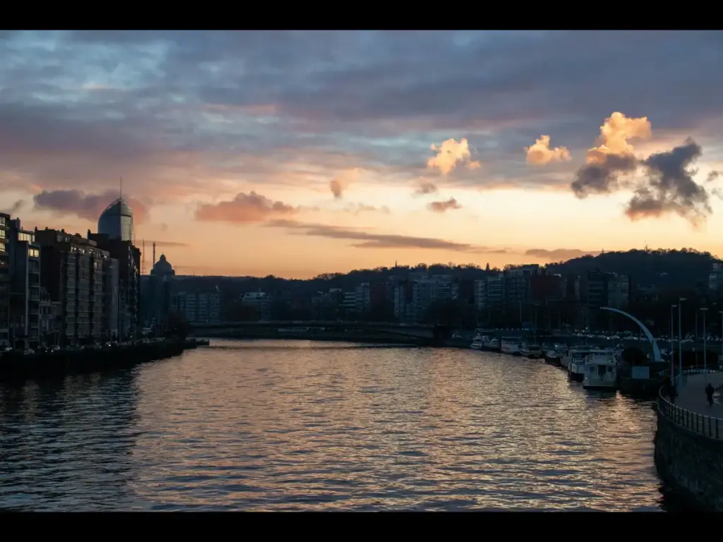 Image of sunset over the Meuse River in Liege, Belgium , courtesy of Tarryn Grignet on Unsplash