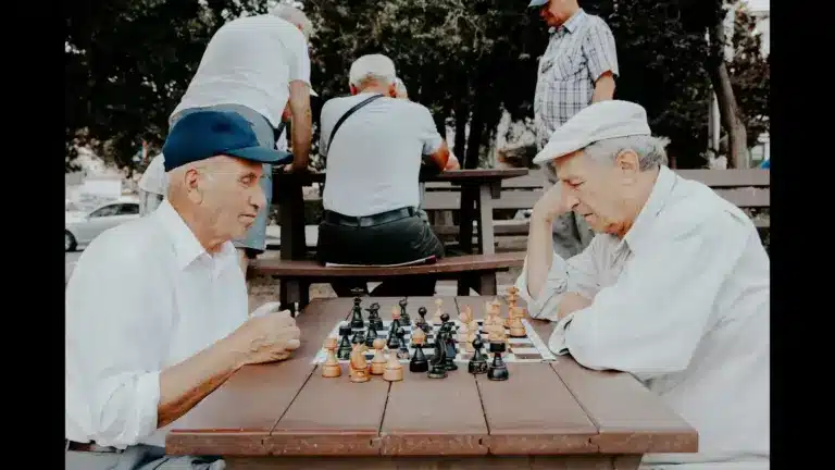 Two older men with good brain health playing Chess.