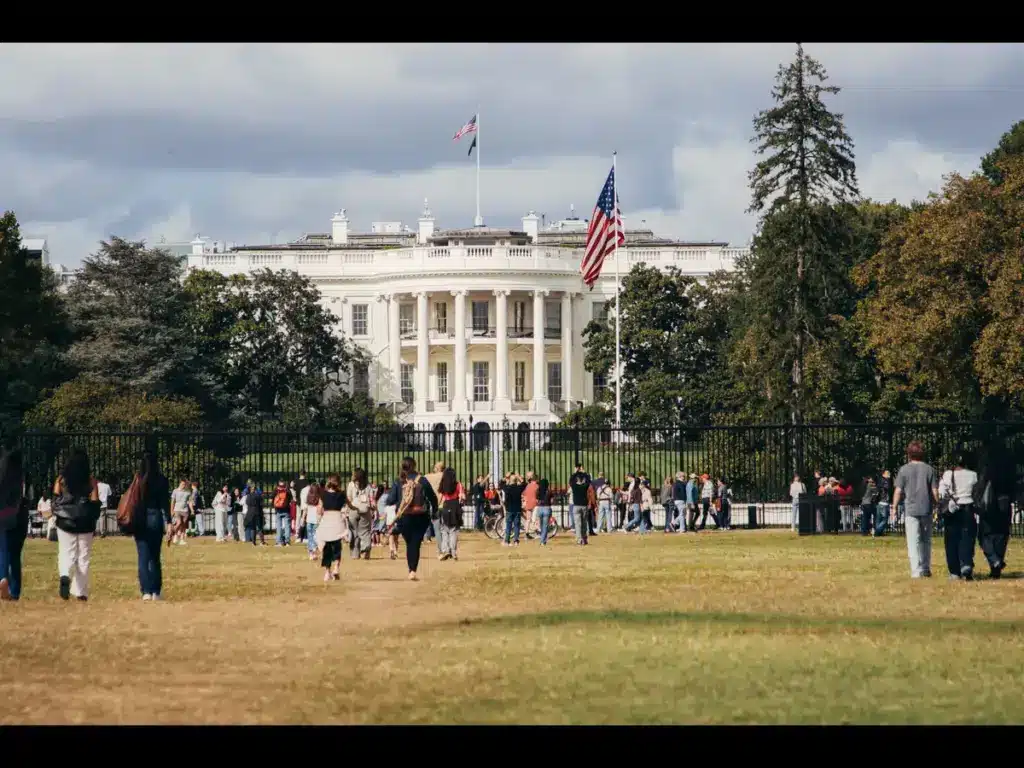 People surrounding and walking around the White House in Washington DC